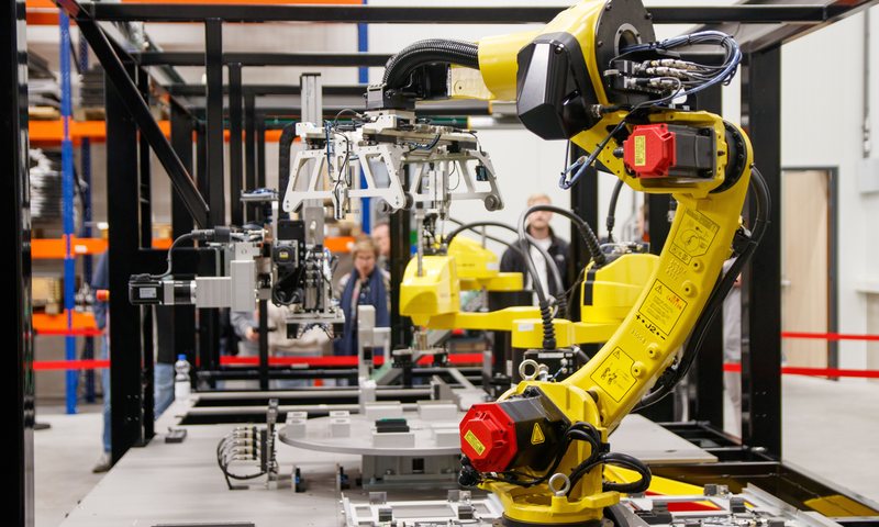 Yellow industrial robotic arm in a manufacturing facility